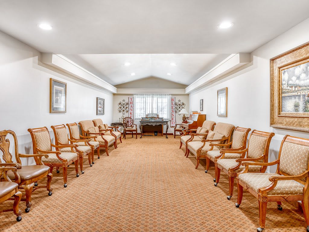 A spacious room with elegant seating arranged in rows.