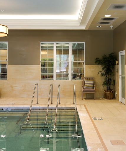 A serene indoor pool area with elegant decor, perfect for relaxation and wellness.