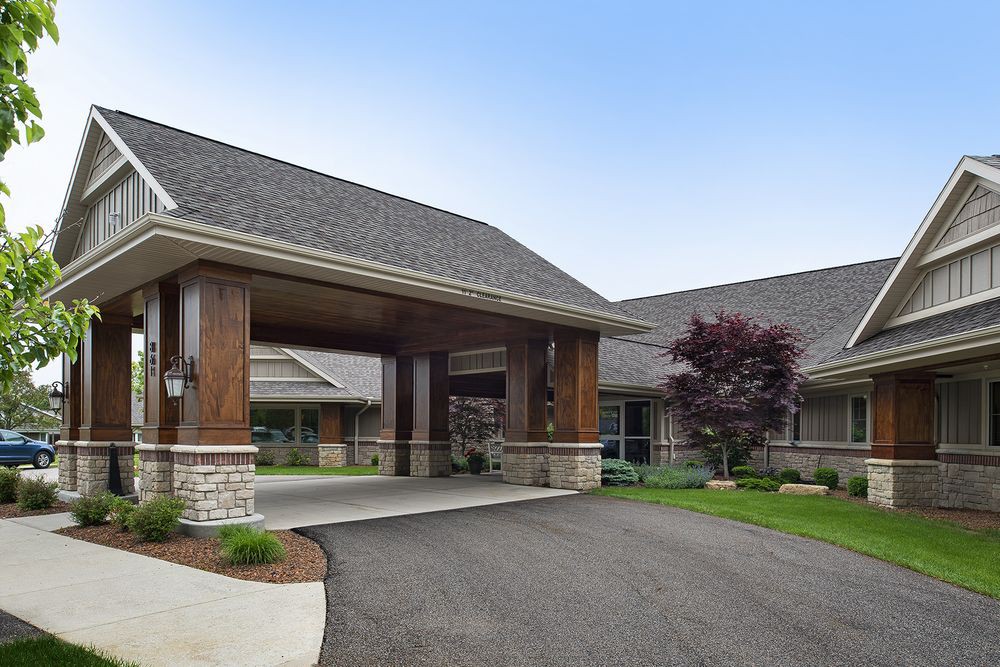 A modern building with a covered entrance and well-maintained landscaping.