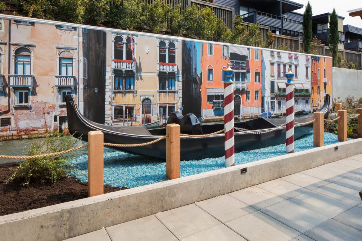 A mural depicting a Venetian scene with a gondola and colorful buildings.