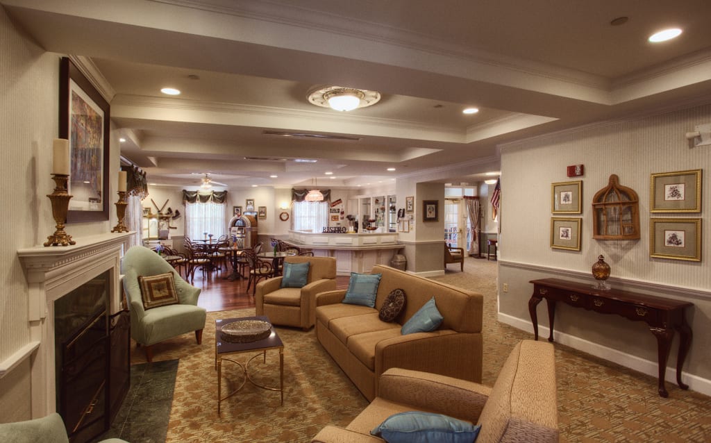 A spacious and well-decorated living room with comfortable seating and warm lighting.