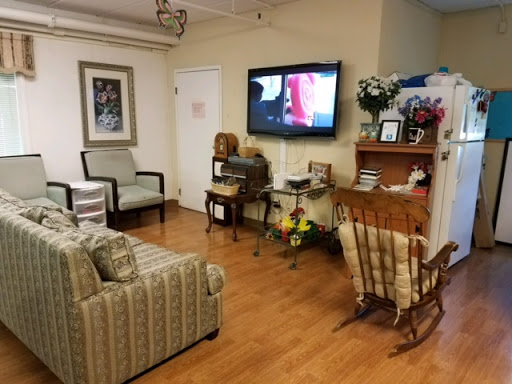 A cozy living room setup featuring a sofa, chairs, and a television.