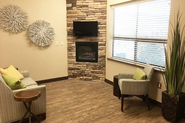 Cozy living room with a fireplace and seating area.