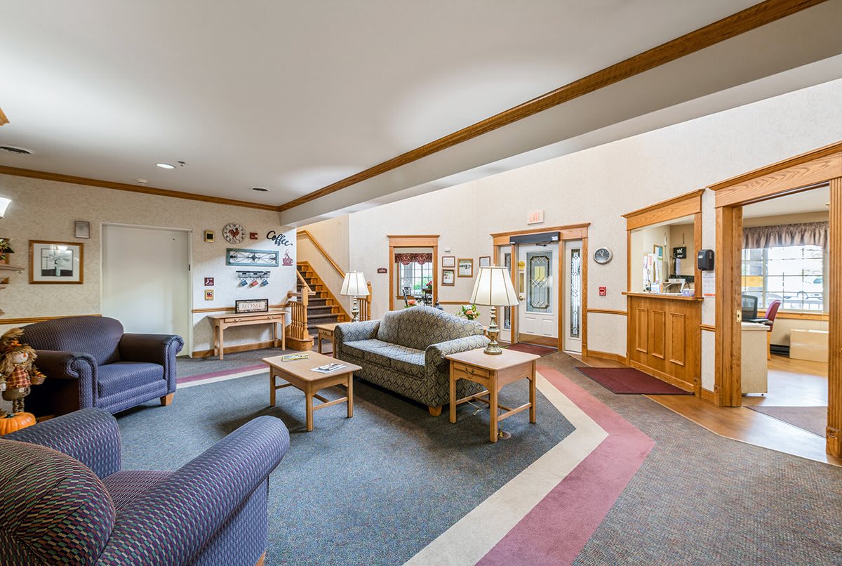 A cozy living room with comfortable sofas, a coffee table, and wooden accents.