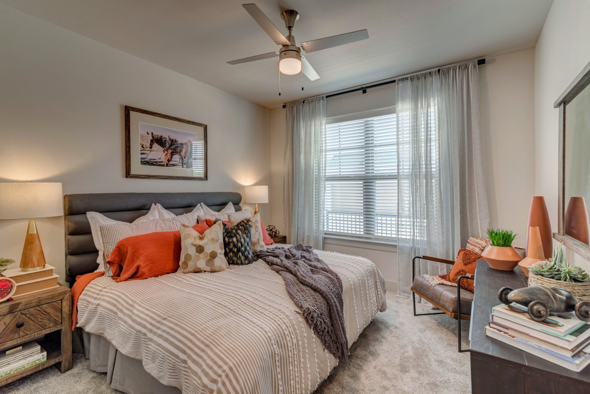 A cozy and well-decorated bedroom with a large bed and soft lighting.