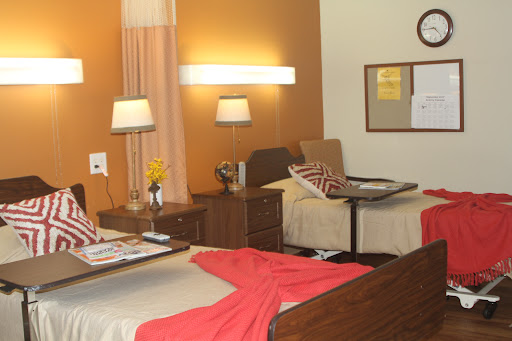 A cozy and well-lit room featuring two beds, stylish furniture, and warm color tones.