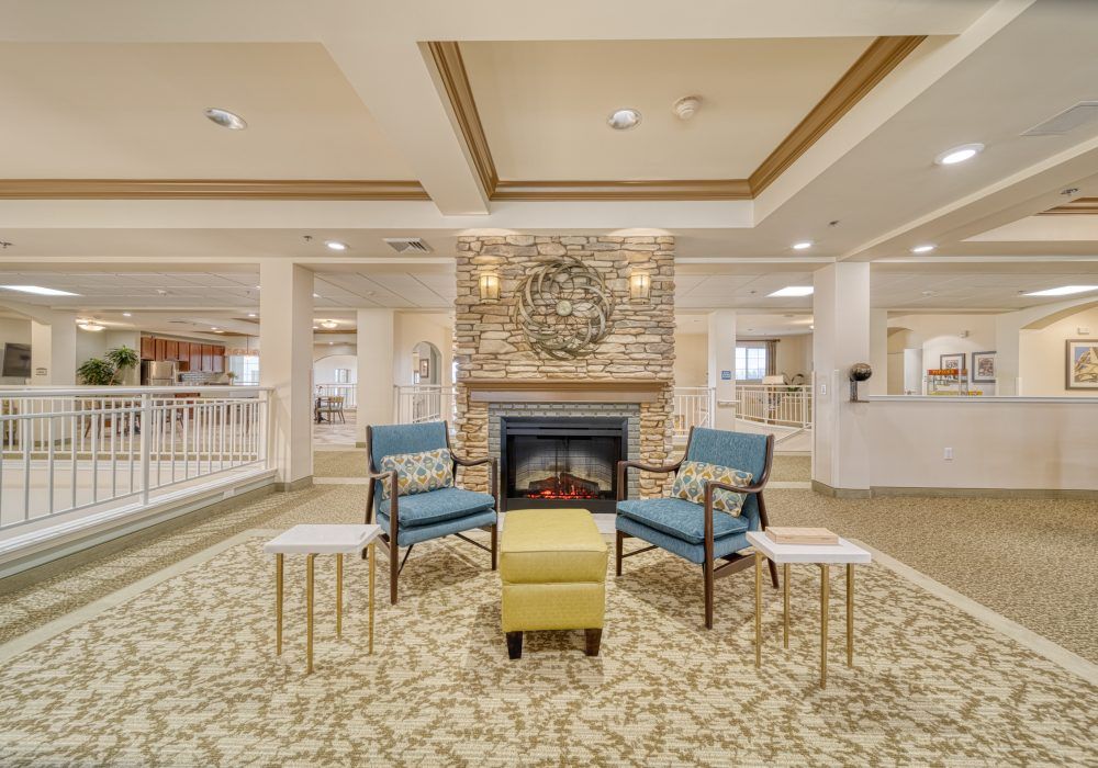 A cozy lounge area with a fireplace, featuring modern seating and elegant decor.