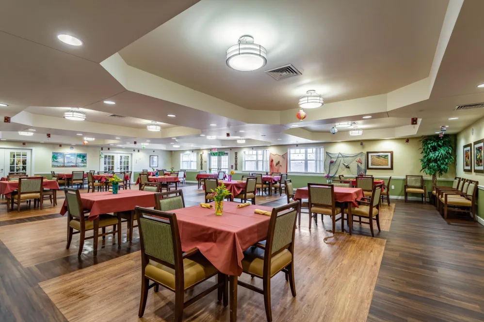 Spacious dining area with elegantly arranged tables and warm lighting.