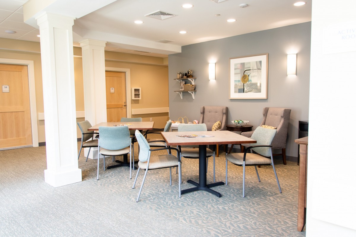A modern and well-lit seating area with tables and chairs in a contemporary interior space.