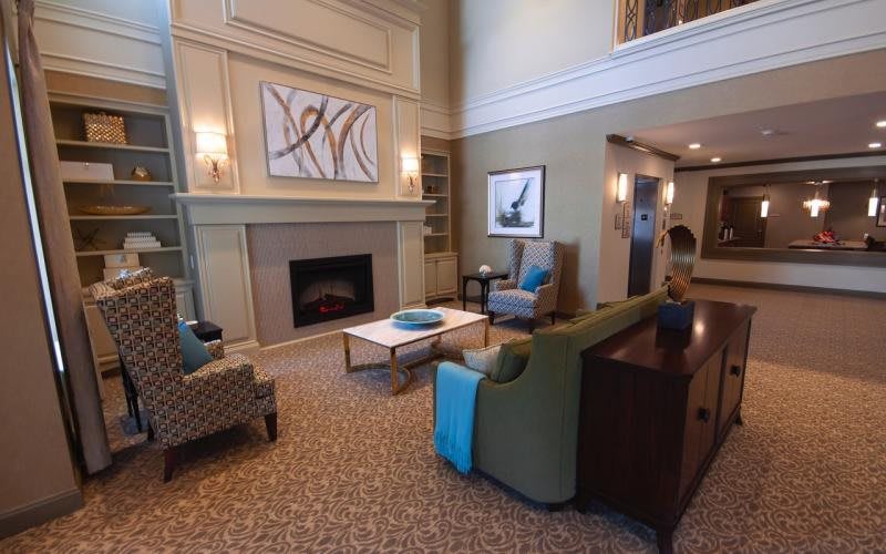 A cozy and modern living room featuring a fireplace, comfortable seating, and elegant decor.