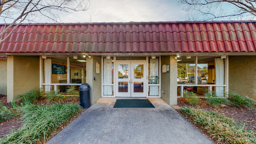 The inviting entrance of a commercial building with landscaped surroundings.