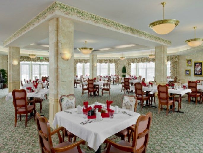 An elegant dining room with neatly arranged tables and chairs, ready for guests.