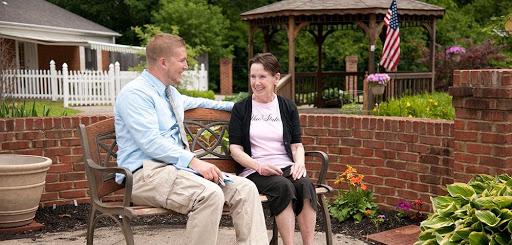 Two friends enjoying a pleasant conversation on a park bench.