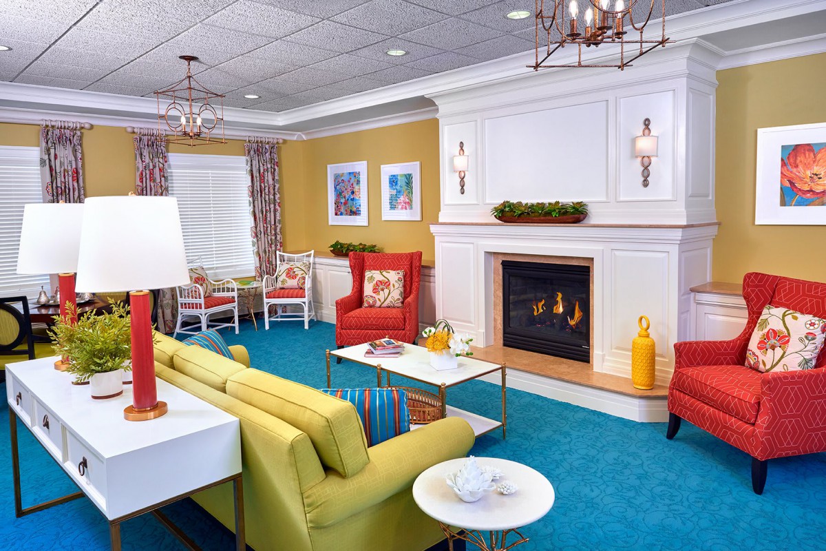 A vibrant and colorful living room featuring modern furniture and a cozy fireplace.