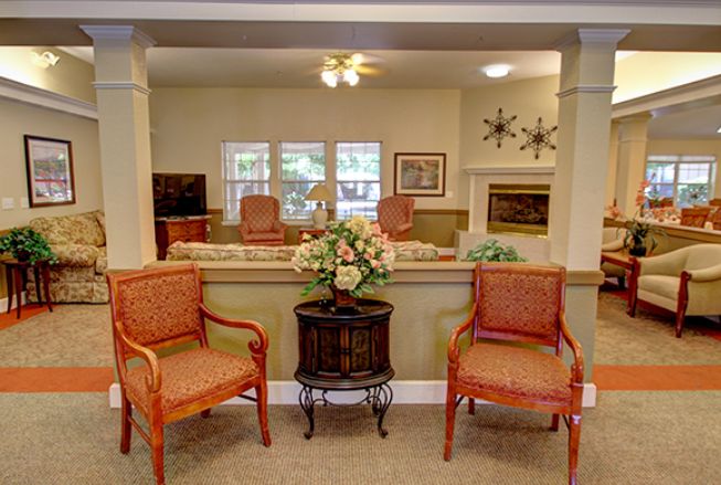 A cozy living room with comfortable chairs and a decorative table centerpiece.