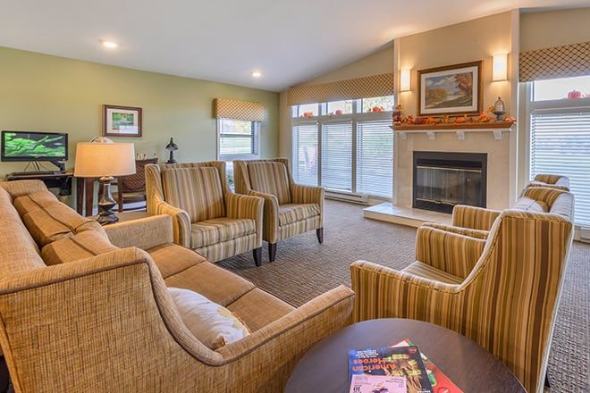 A cozy living room with comfortable seating and a fireplace.