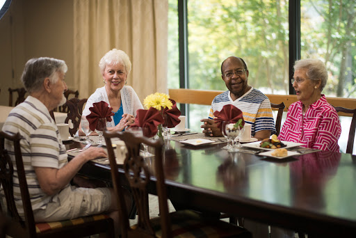 A joyful gathering of friends enjoying a meal together.
