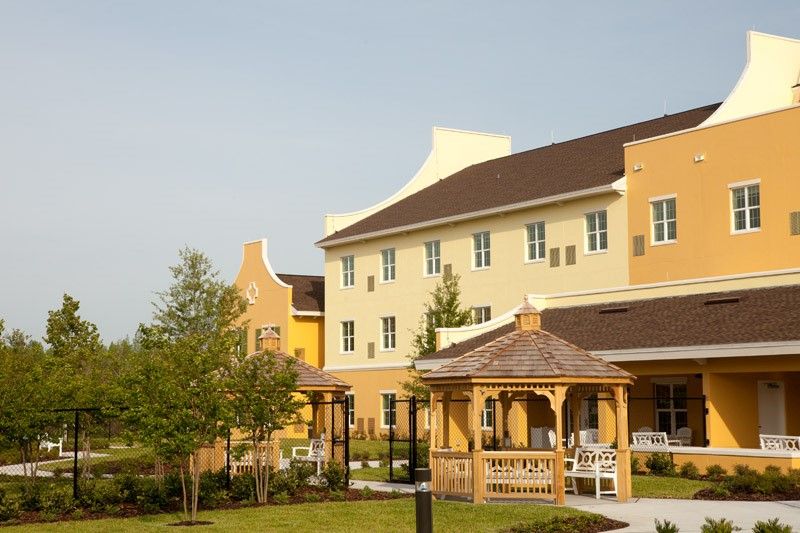 A residential building with a gazebo and surrounding greenery.