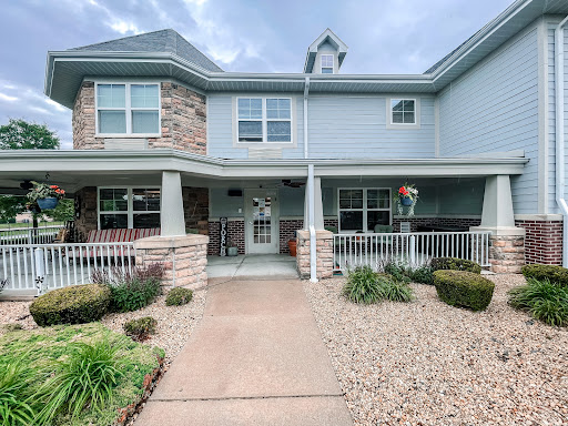 A beautifully designed residential building with welcoming landscaping and a charming front entrance.