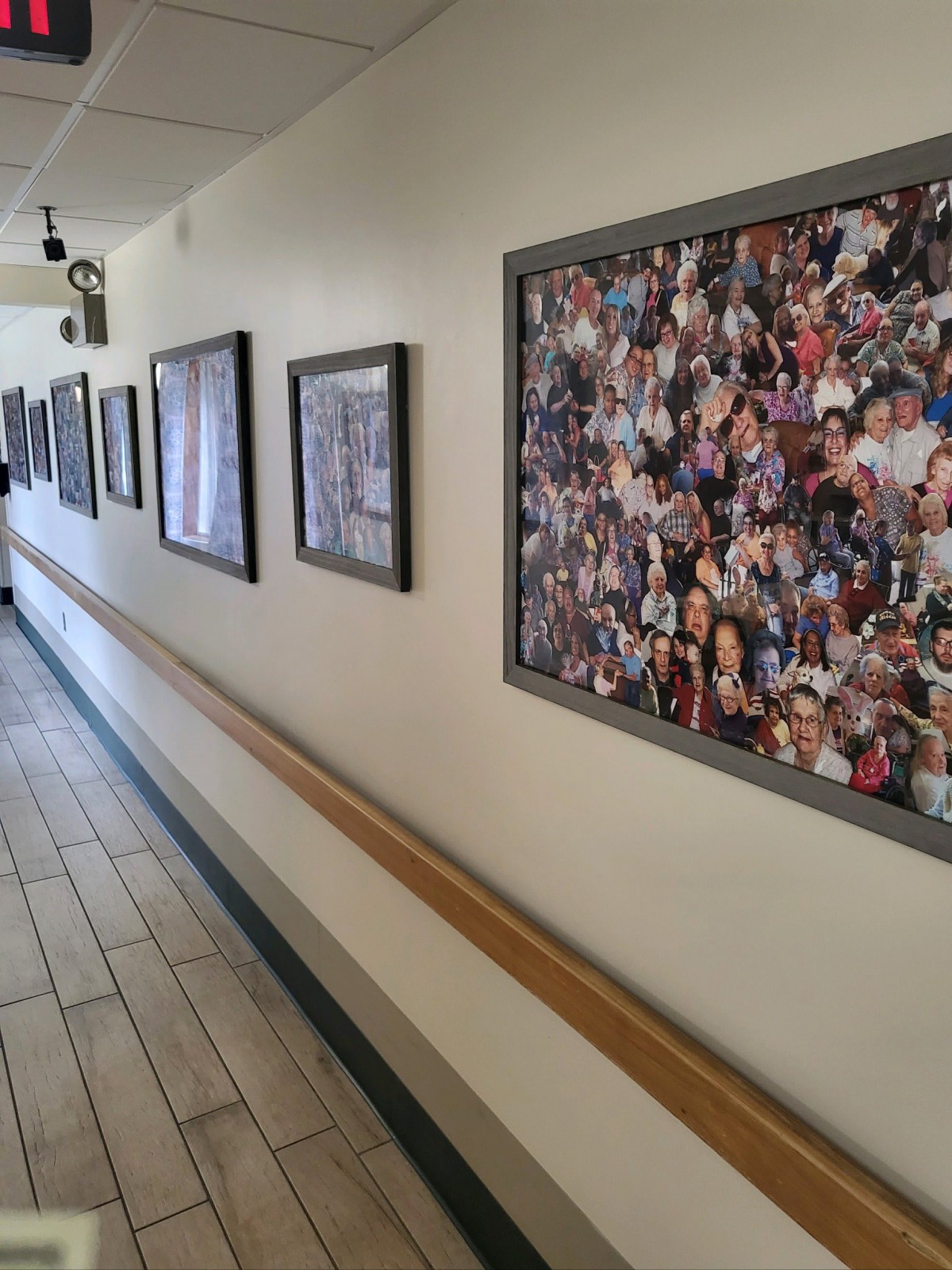 A corridor featuring framed photographs and artwork displayed on the walls.