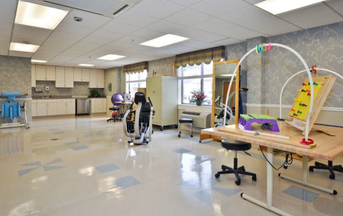 A spacious physical therapy room equipped with various rehabilitation and exercise equipment.