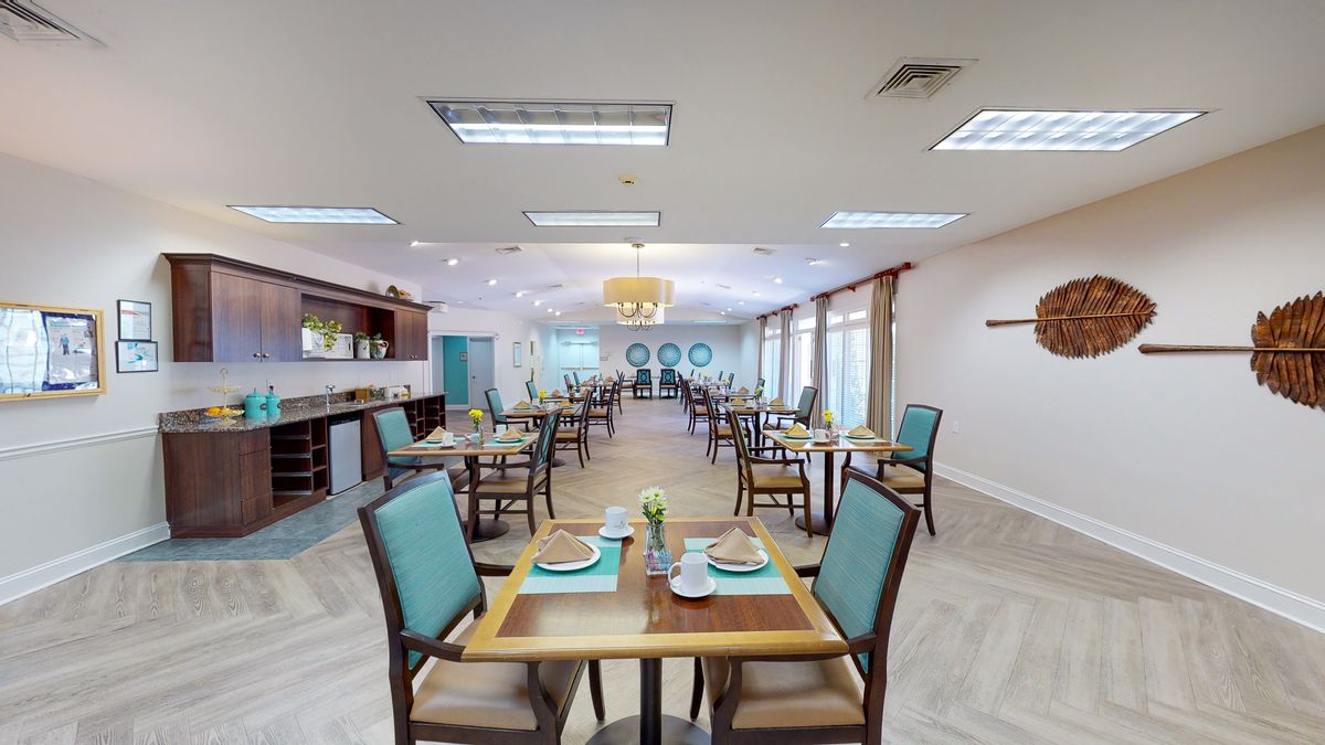 A modern dining room with neatly arranged tables and chairs, ready for guests.