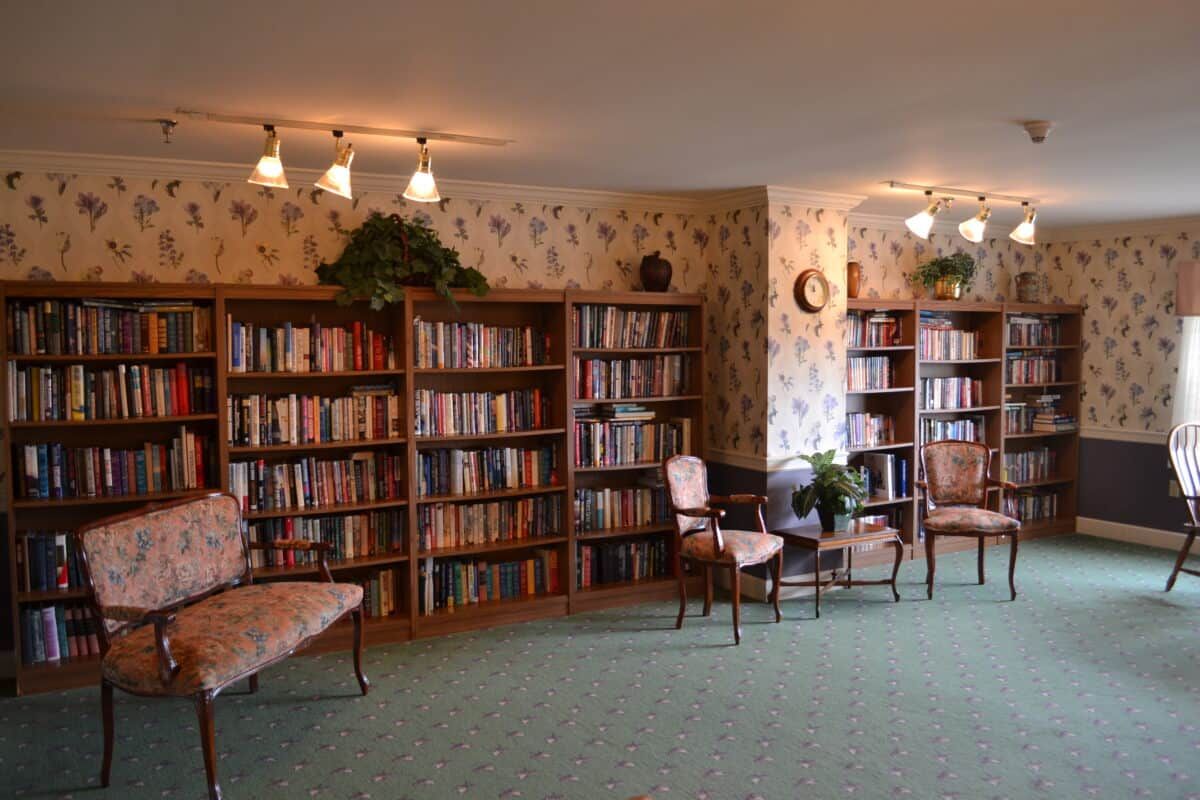 A cozy library with bookshelves and seating arrangements.