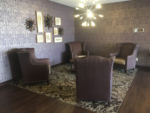 A stylish living room setup featuring cozy seating, modern decor, and ambient lighting.