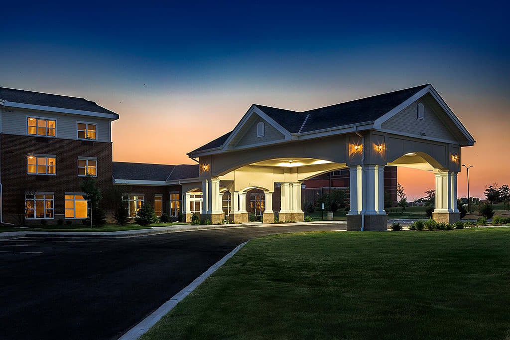 A beautifully lit hotel entrance at sunset.