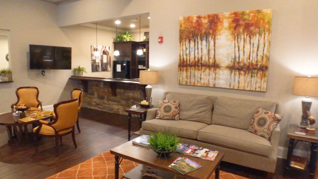 A cozy living room with a comfortable sofa, warm lighting, and autumn-themed decor.
