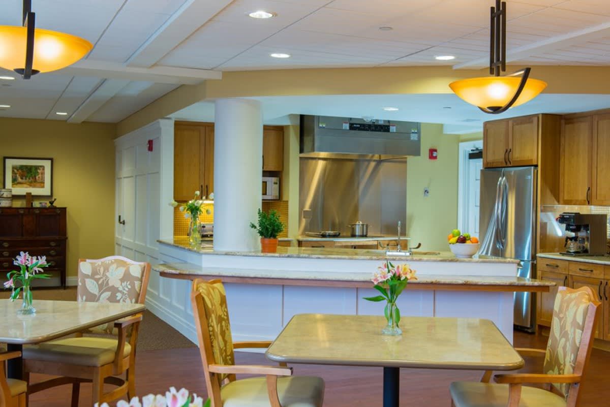 A modern kitchen and dining area with cozy decor and warm lighting.