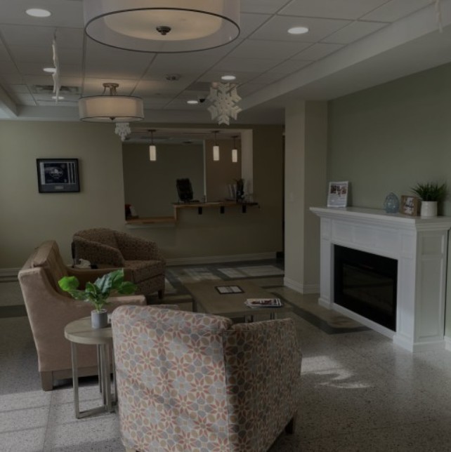 A modern and cozy living room featuring a fireplace and comfortable seating.