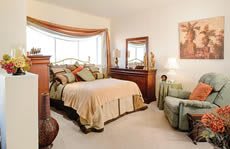 A cozy bedroom with elegant furnishings and warm decor.