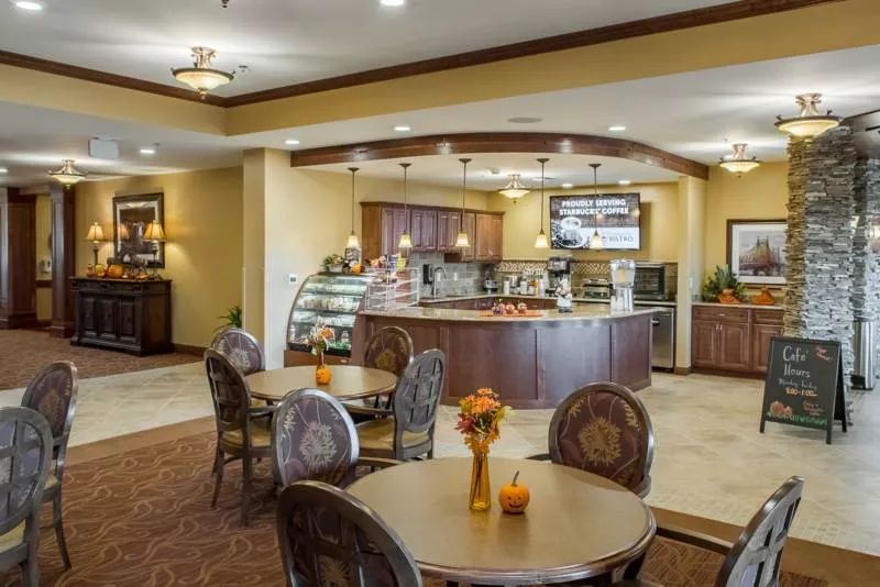 A cozy cafe interior with a seating area and a display counter.