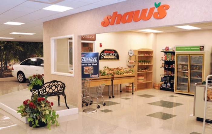 A view of the entrance to Shaw's supermarket with a welcoming interior display.