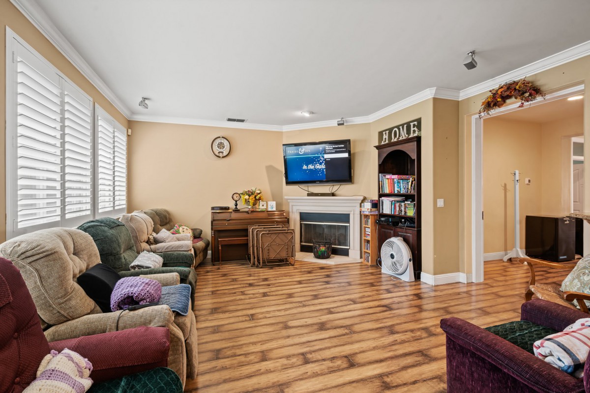 A cozy living room with a fireplace, television, and comfortable seating.
