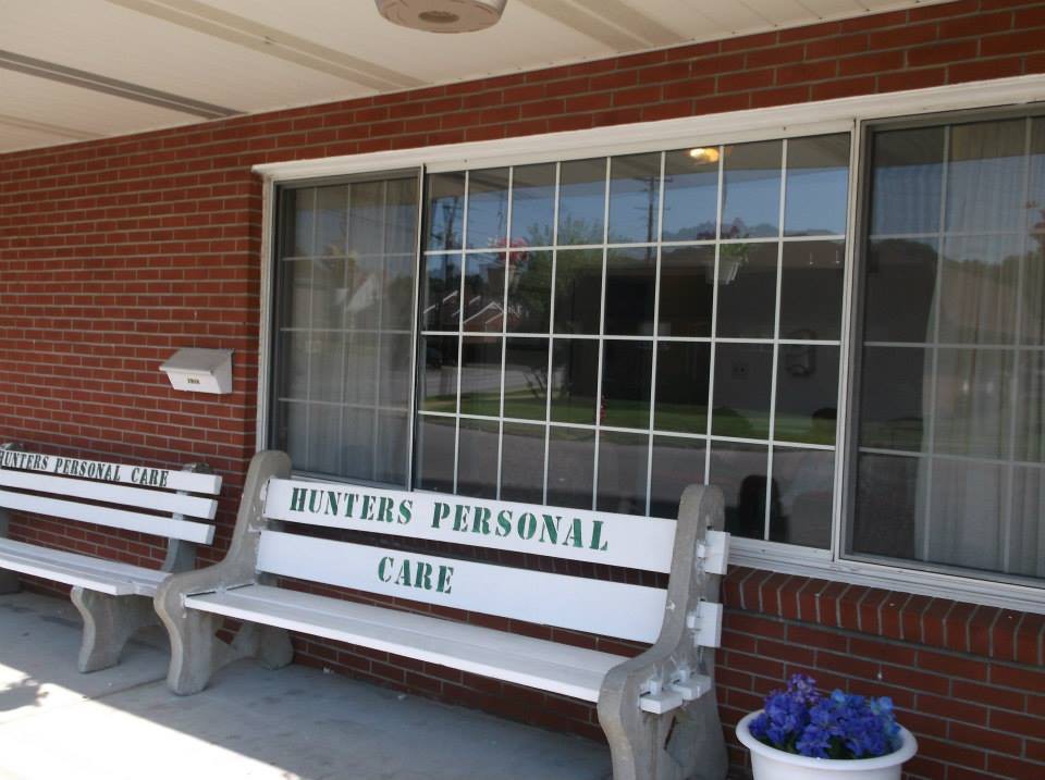 A bench labeled 'Meyers Personal Care' outside a brick building with a large window.