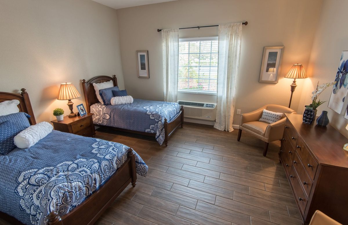 A cozy bedroom with two beds and elegant decor.