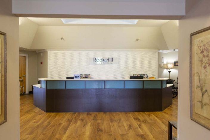A modern hotel reception desk in a lobby.
