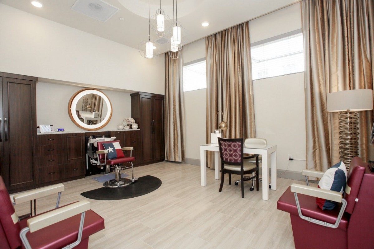 A modern salon interior with hairdressing chairs and elegant decor.