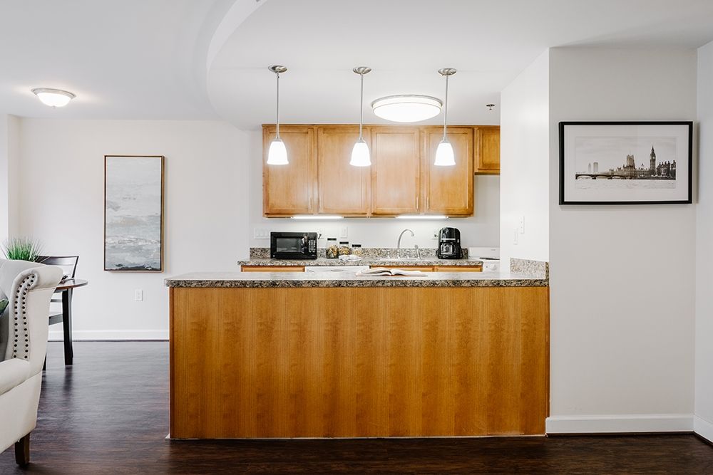 Modern kitchen with wood cabinets and pendant lighting.
