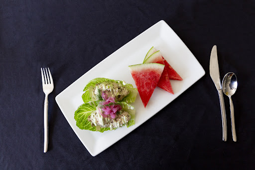 A refreshing salad featuring lettuce wraps and vibrant watermelon slices.