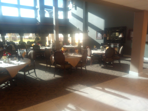 A well-lit dining area showcasing elegant tables and chairs, enhanced by striking sunlight patterns.