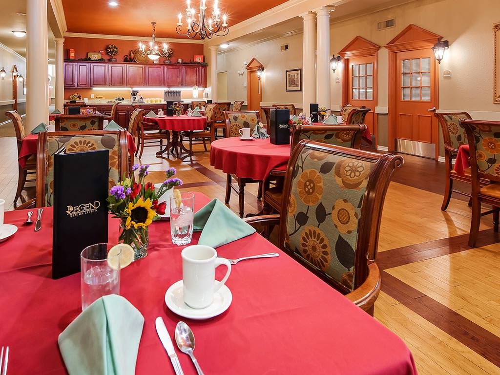 A well-decorated restaurant dining room with tables set for a meal.