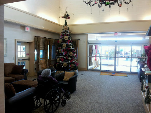 A cozy lobby adorned with a festive Christmas tree, featuring seating and accessible options.