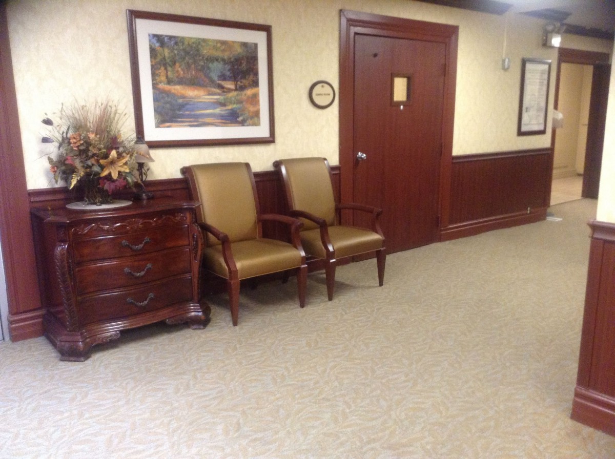 A cozy waiting area with chairs and artwork on the wall.