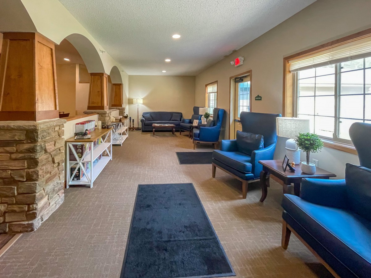 A cozy living room with comfortable seating and warm lighting.