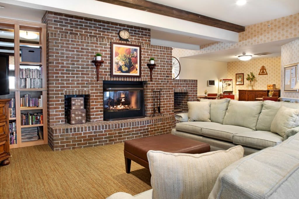 A cozy living room featuring a brick fireplace and comfortable seating.