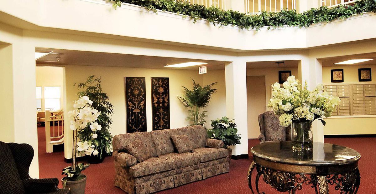 Elegant lobby area with decorative plants and artwork.