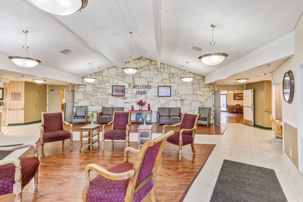 A well-lit waiting area with comfortable seating and a stone accent wall.